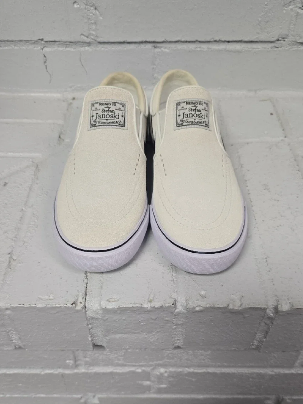 Nike Slip-On Sneakers in Off-White with Black Swoosh